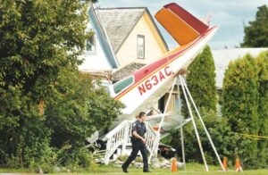 Photo of an airplane that lost power on final approach and crashed into a home.